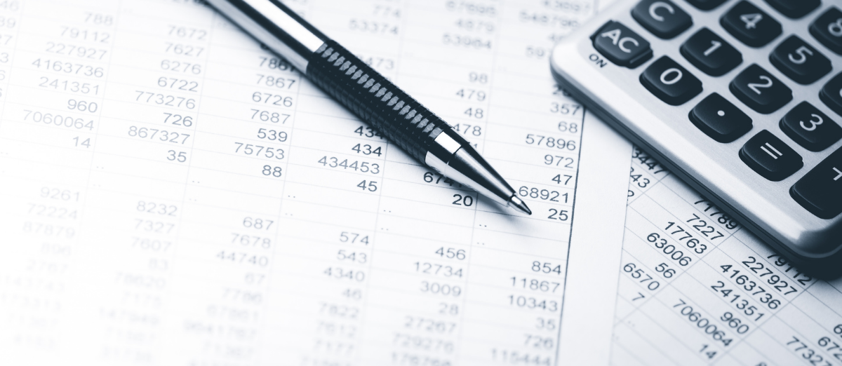 Pen, calculator, and sheet of account balances