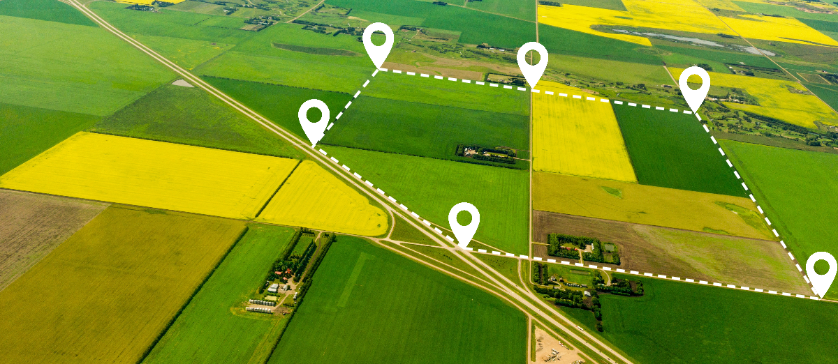 Aerial view of farmland with location icons indicating a specific plot of land