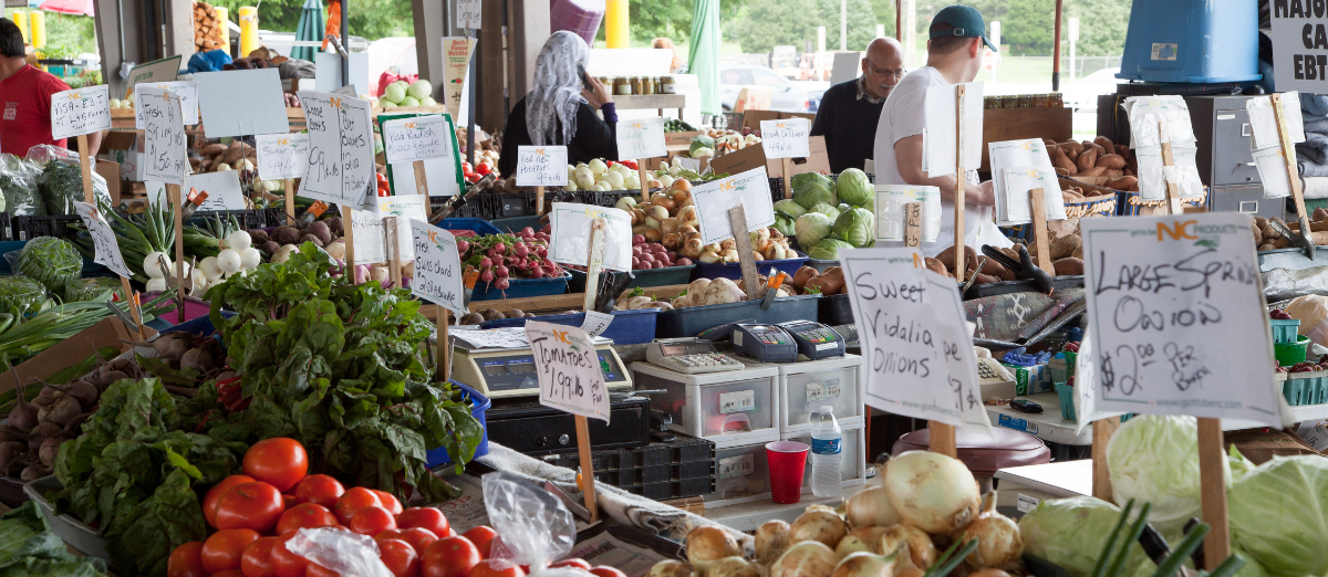 Image of farmers market with various fruits and vegetables for sale