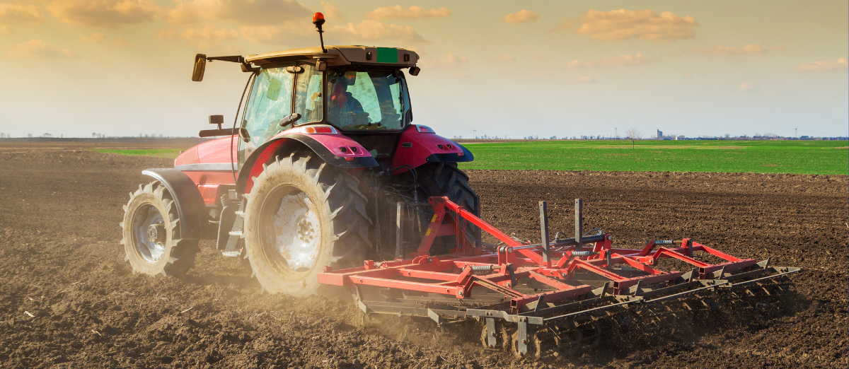 Photo of tractor pulling a cultivator through a field