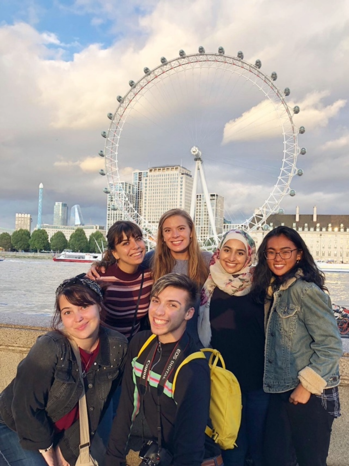 Zoe Gabrielson's education abroad trip to London, group photo of students she met standing in front of a river and Farris wheel