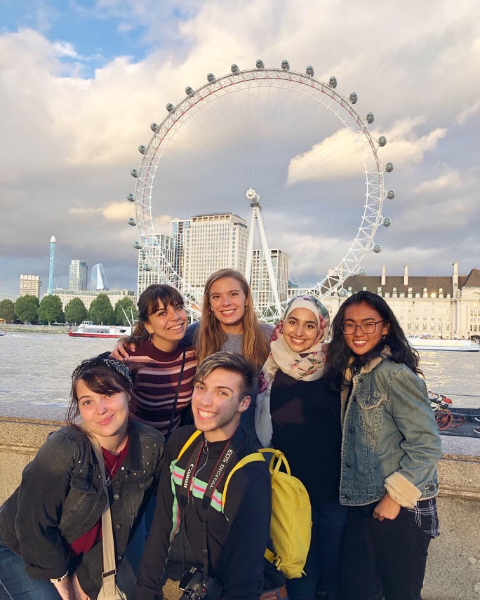 Zoe Gabrielson's education abroad trip to London, group photo of new friends standing in front of river and farris wheel