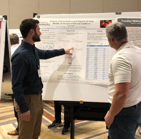 Graduate Student Thomas Pierce discussing his poster with attendees at annual meeting
